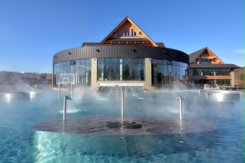 The Szaflary thermal pools with the bathhouse building behind them